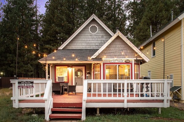 The spacious front deck is more charming at night. 