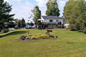 Backyard view of home with lake views