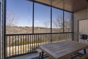Covered, screened in patio overlooking golf course.