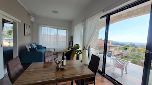 Spacious living room and dining area with panaromic sea view