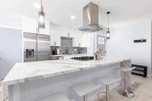 Wide kitchen island counter space. Beautiful marble design. Four bar stools for extra dining seating.
