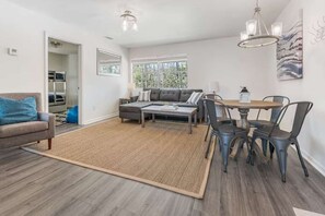 Spacious, open-concept design seamlessly connecting the living room and kitchen for a bright and airy feel.