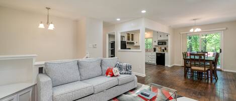 Open-Concept Living Area with Ample Seating, Roku TV , Kitchen, and Dining Room