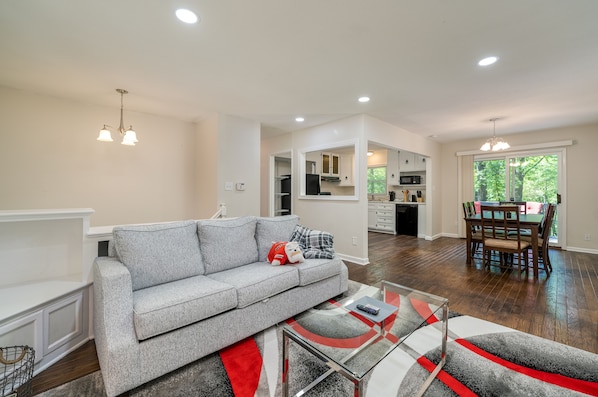 Open-Concept Living Area with Ample Seating, Roku TV , Kitchen, and Dining Room