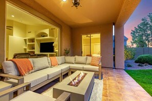 Covered Patio with plenty of seating and a cozy firetable feature