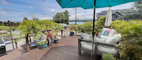 Decks overlooking Lake Washington with fire table and seating. 