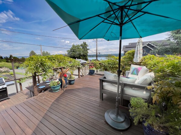 Decks overlooking Lake Washington with fire table and seating. 