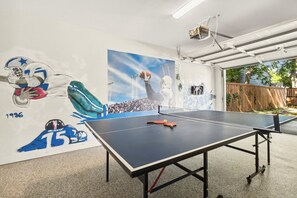 Ping pong and darts in detached garage in back yard