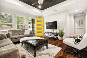 Gather in the spacious family room with plenty of comfortable seating and large smart TV