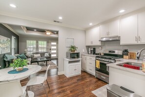 Fully stocked kitchen with dishes, pots and pans, utensils and all the odds and ends