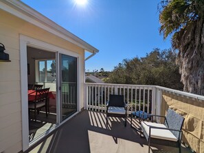 Sunny deck off kitchen is private and has a cozy seating area.