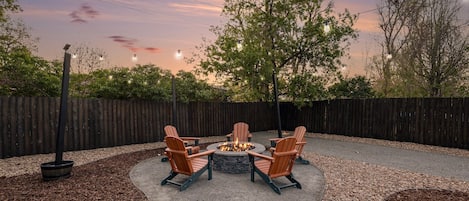 Relax in our beautifully designed outdoor area with custom gas firepit, Adirondack seats and ambient lighting, the perfect focal point for evenings under the stars.