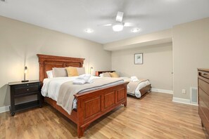 Our Queen bedroom features a Queen bed, Full bed, dresser, closet, 36-inch Insignia Smart TV and nearby bathroom.