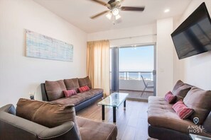 Come into this comfy living room with a view of the bay & ocean