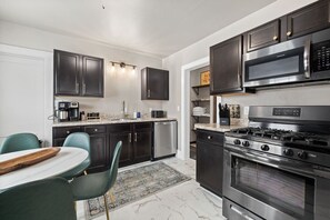 Fully stocked kitchen with modern appliances, cookware, and essentials, ready for all your culinary needs.