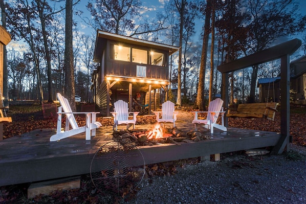 The back of the Tiny House featuring the lake and fire pit.