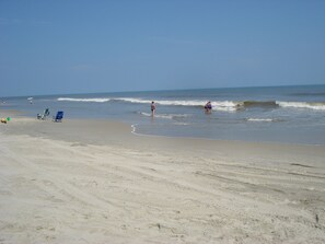 The waves along the beach are enjoyable to play in. 
