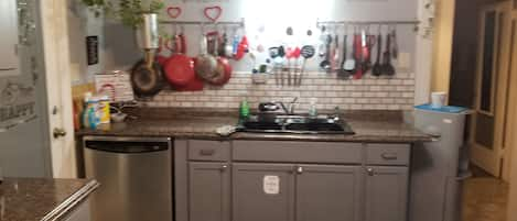 The main floor kitchen, with dishwasher and plenty of utensils and cookware