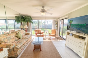 The open floor plan great room includes a queen sized sofa sleeper and additional coordinating seating.