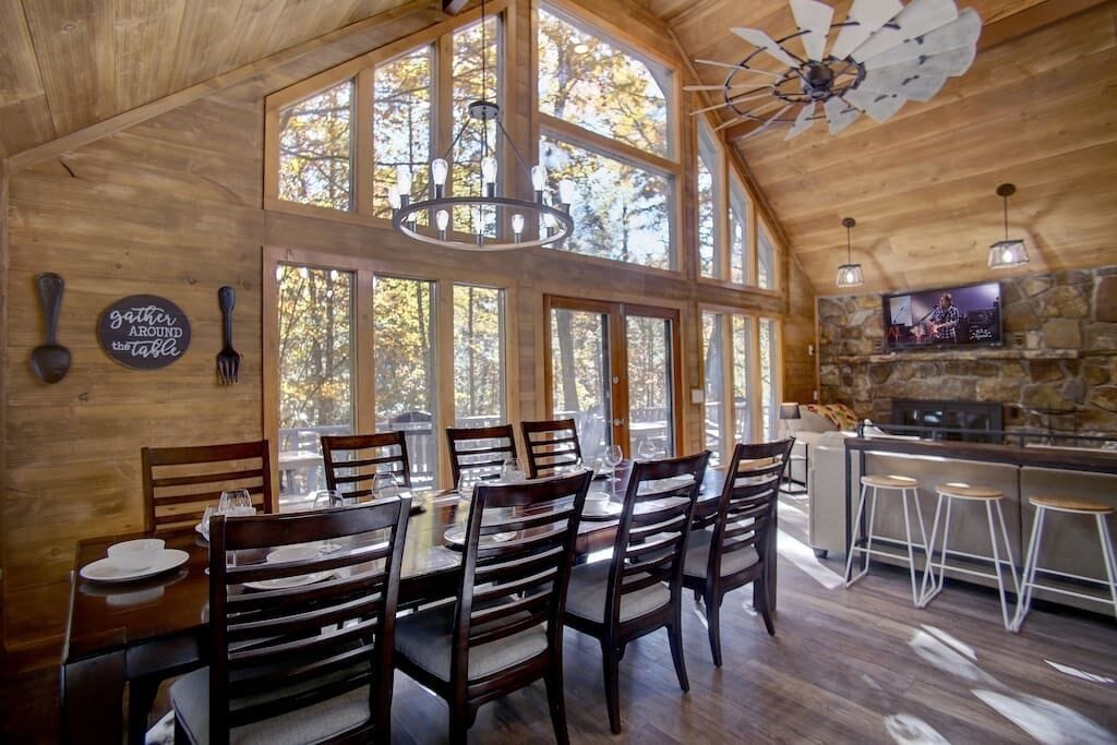 Feel immersed in the trees in this open concept space while enjoying each other's company around the dinner table or relaxing in the living room. In the winter you can get cozy on the couch in front of the wood burning fireplace.