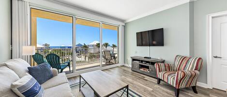 Living room. Step out to balcony overlooking pool and ocean.