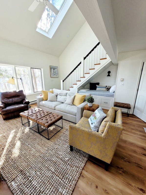 Cozy living room with natural burning fireplace and gorgeous lake views! 