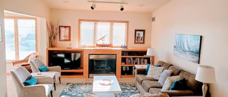 Cozy up in our inviting living room with a gas fireplace and TV