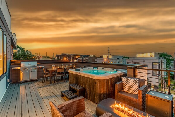 2nd Unit- Private outdoor rooftop deck with stunning city views featuring a relaxing hot tub, firepit with outdoor furnishings, BBQ grill, and outdoor dining.