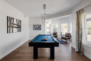 Game room with pool table and seating area.