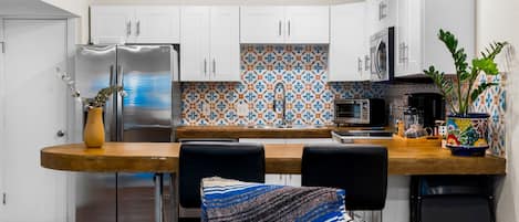 Two modern bar seats complement a stylish kitchen table for a sleek look.