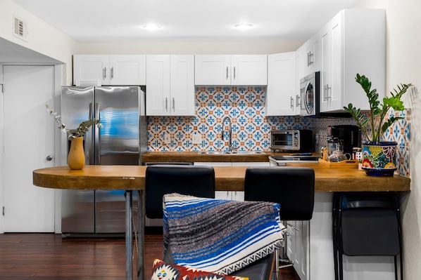 Two modern bar seats complement a stylish kitchen table for a sleek look.