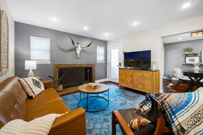 Warm and welcoming living area, adorned with Spanish-inspired details and a cozy fireplace.