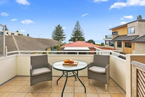 Patio leading off living area on upper level.