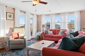 Ample windows fill the living room with natural light and beautiful ocean views!