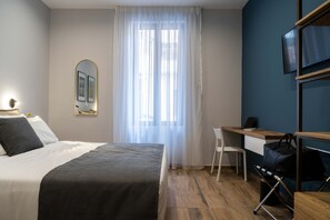 Queen-sized bed with desk and wardrobe