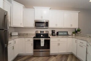 Updated kitchen with stainless steel appliances and granite counters