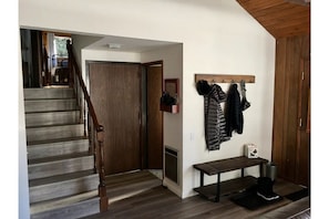 Entry and door to the laundry room and
 to the left, stairs up to the bedrooms.