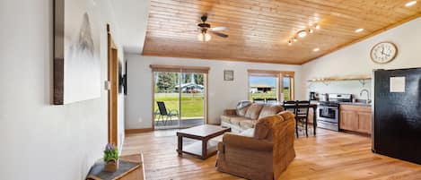 Open concept living, kitchen and dining area with gorgeous vaulted ceilings. 