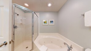 Unwind in opulence: This master en-suite bath is your personal oasis, complete with a sumptuous jacuzzi tub and a separate walk-in shower for the ultimate in relaxation.