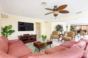 A comfy living room with a large flat screen TV