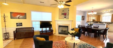 The spacious living room has a 55 inch smart TV with streaming applications.
