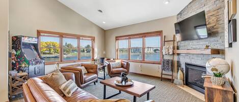 The living room offers leather seating and spectacular water views.
