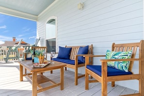Seating area on the balcony to enjoy the sounds of the nearby ocean.