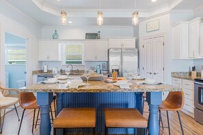 Large island counter provides a central gathering spot for your family meals.