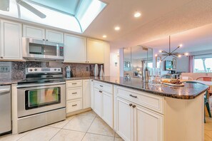 Bright and modern kitchen with sleek finishes and ample space.