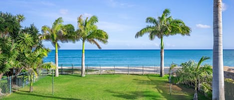 Large yard leading directly out to the sandy beach