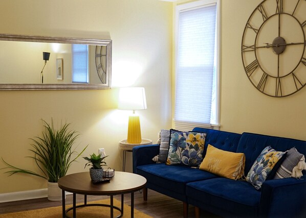 Relax in style with our vibrant blue sofa and a dash of modern decor.