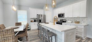 Luxurious kitchen features an Island bar.