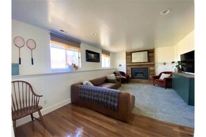 Family room with gas fireplace and smart tv. 