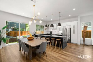 Large kitchen and dining room with slider door leading to the backyard